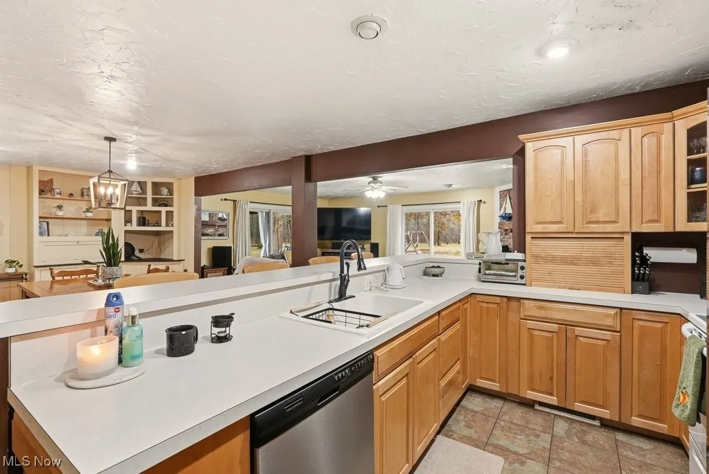 Eat In Kitchen with Breakfast Bar with 4 Chairs, Wood Fireplace, Garbage Disposal, Microwave, Dishwasher, Range, Refrigerator