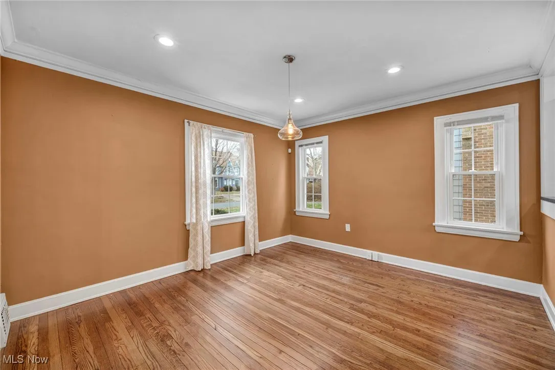 Unfurnished room featuring ornamental molding, light wood-style flooring, and recessed lighting