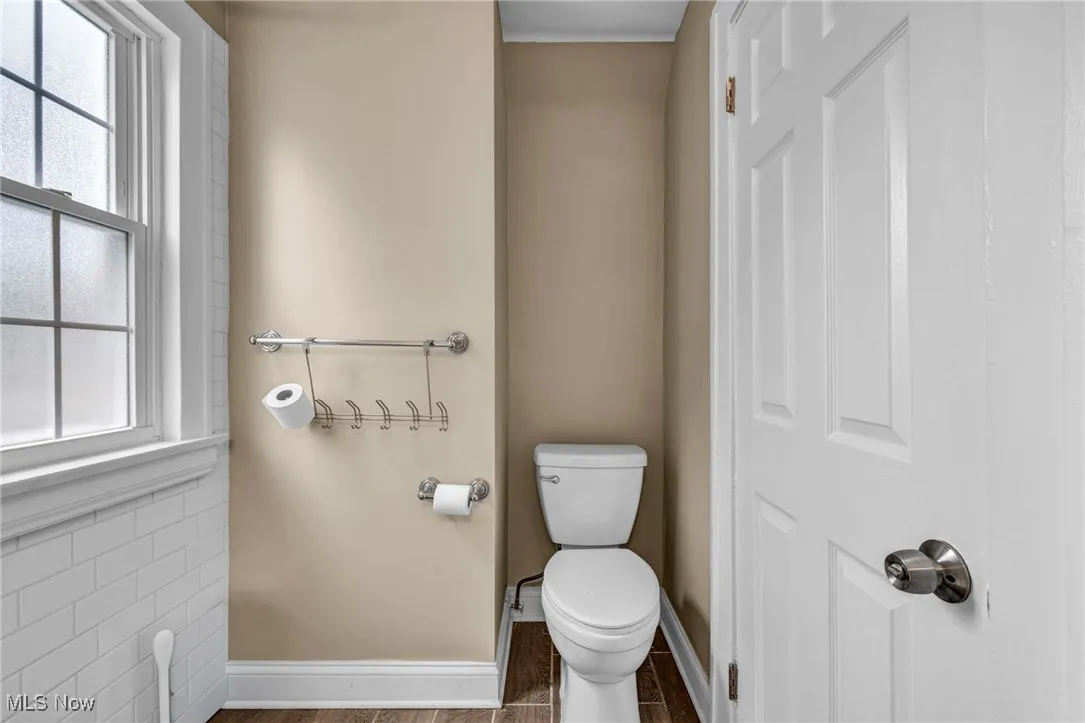 Bathroom featuring healthy amount of natural light and wood finished floors
