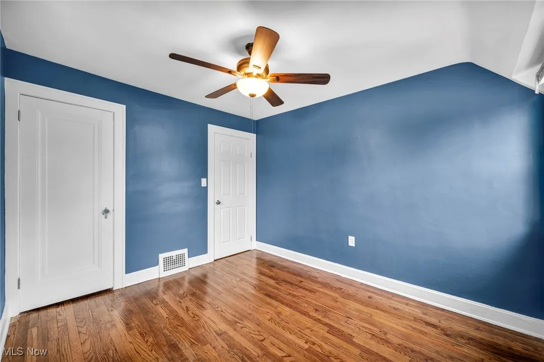 Unfurnished bedroom with wood finished floors and a ceiling fan