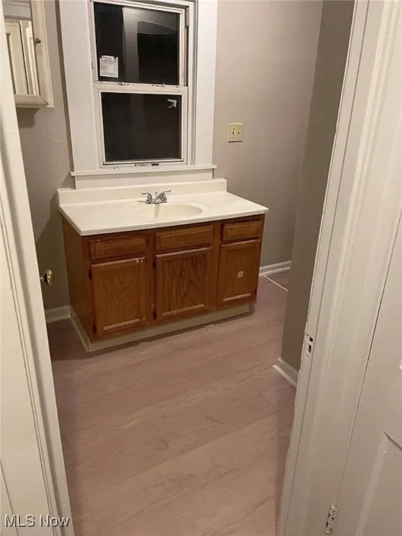 Bathroom featuring vanity and light wood-style flooring