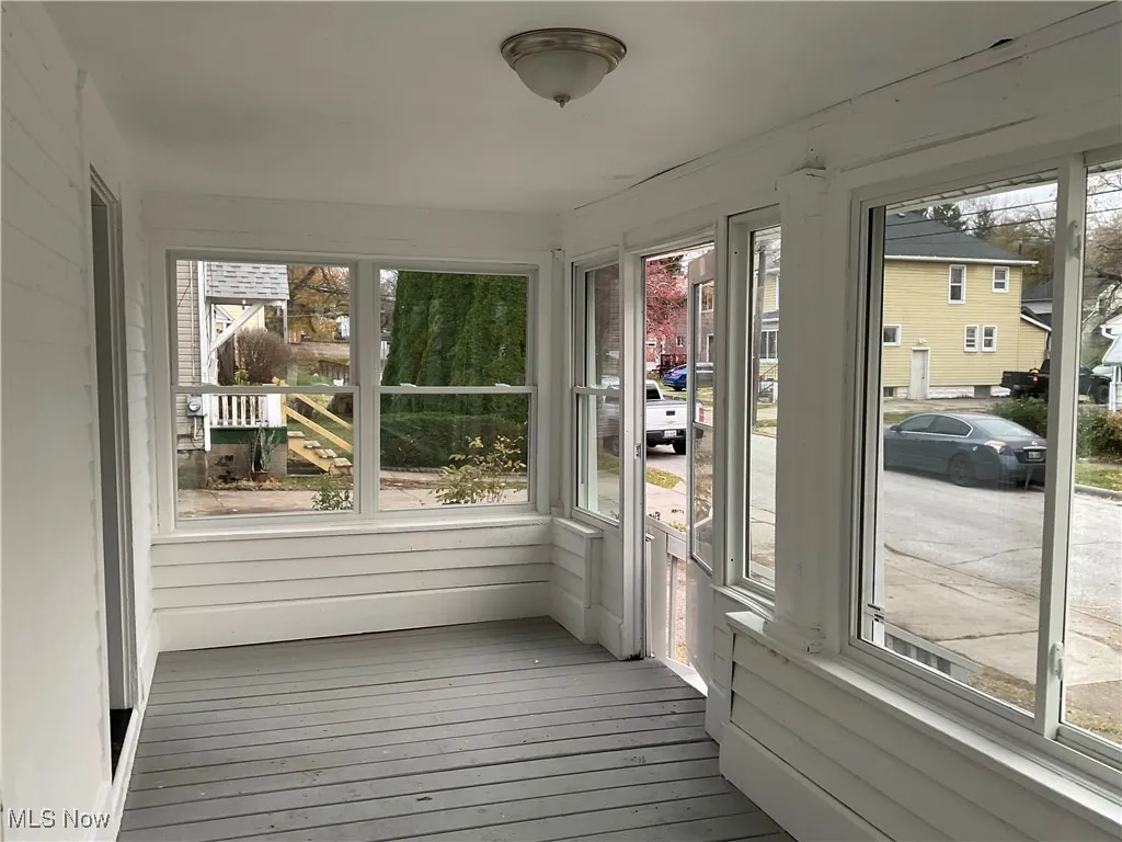 Unfurnished sunroom featuring hardwood / wood-style floors