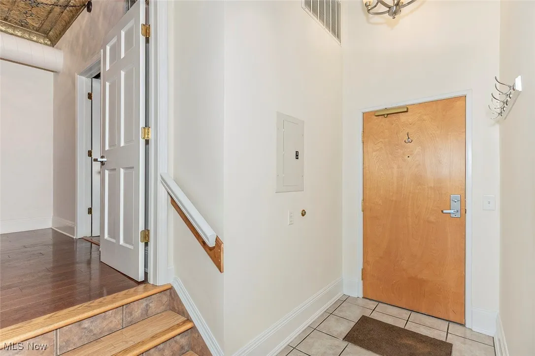 Entrance foyer featuring tile patterned floors and electric panel