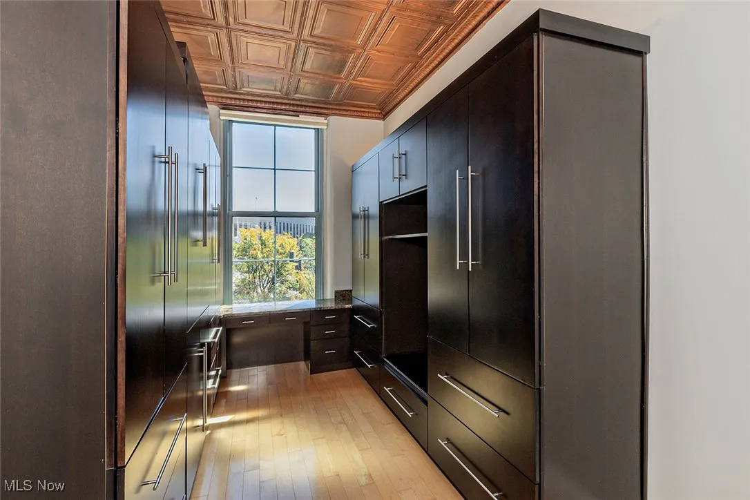 Kitchen featuring an ornate ceiling, light wood finished floors, and modern cabinets
