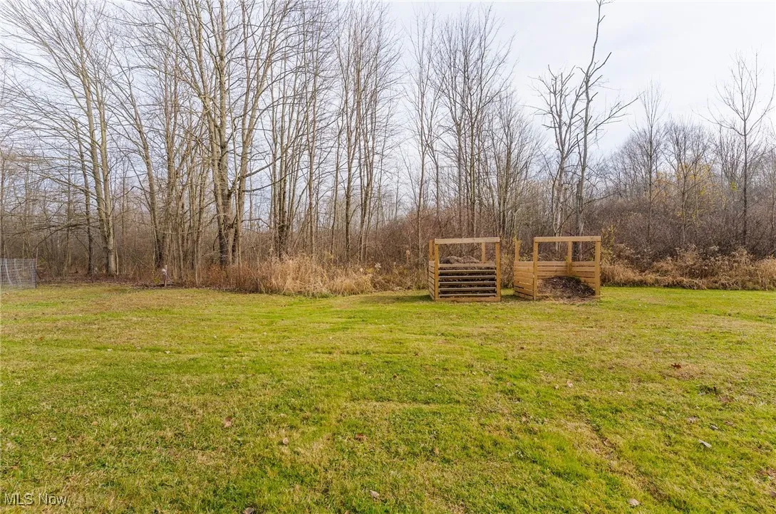 View of green lawn with large compost bins