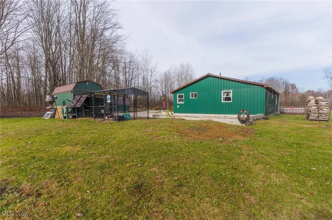 View of yard with shed and chicken coop