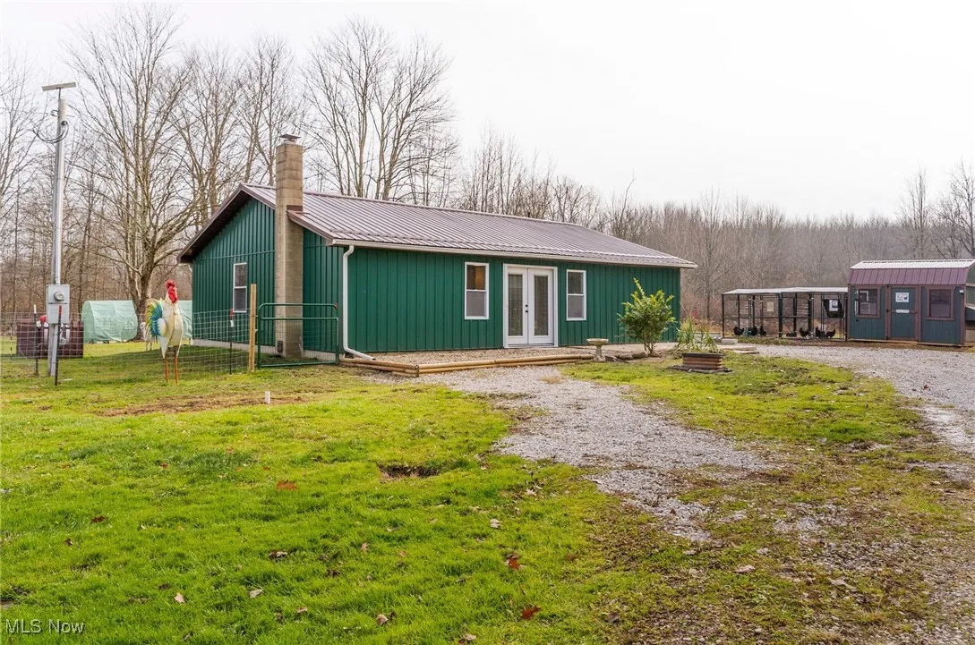 View of front of house featuring an outbuilding, a metal roof