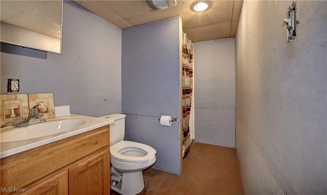 Bathroom with curtained shower and vanity