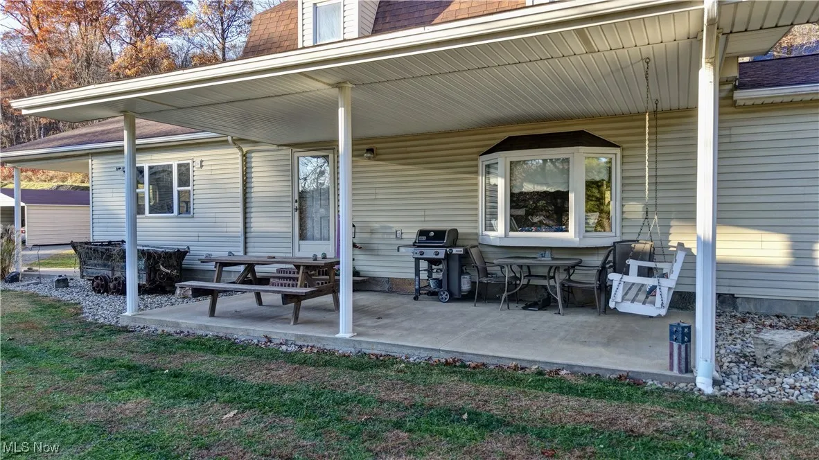 Porch featuring area for grilling and a yard