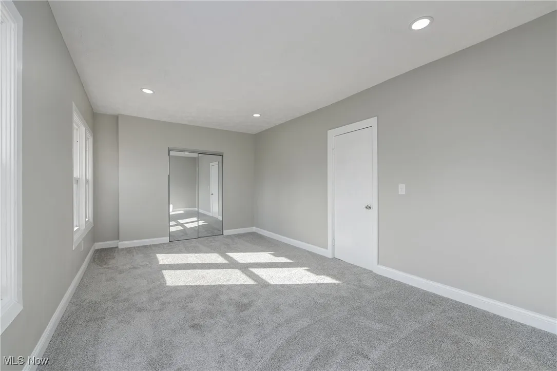 Unfurnished room featuring recessed lighting and light colored carpet