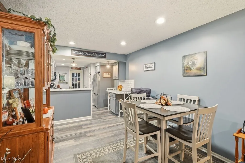 Dining space featuring recessed lighting, a textured ceiling, and light wood-type flooring