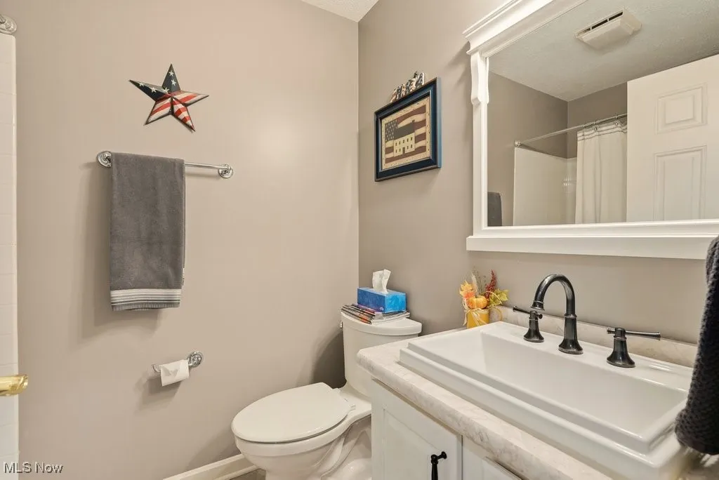 Bathroom featuring vanity and a shower with shower curtain