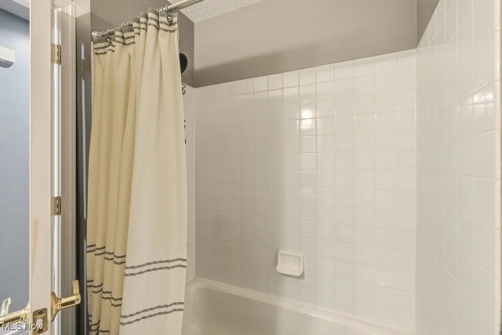 Full bathroom featuring shower / bath combo