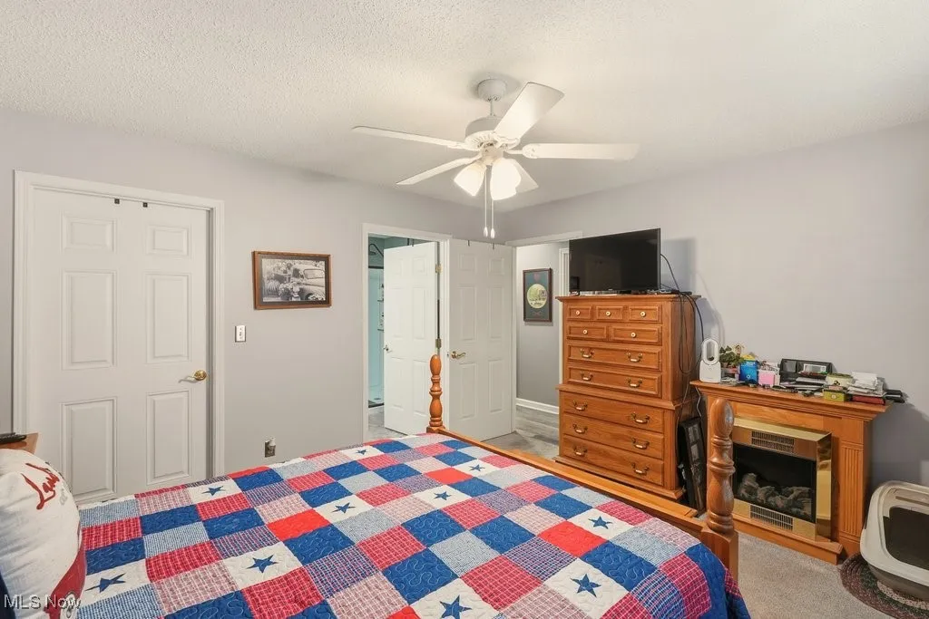 Bedroom featuring a textured ceiling and ceiling fan