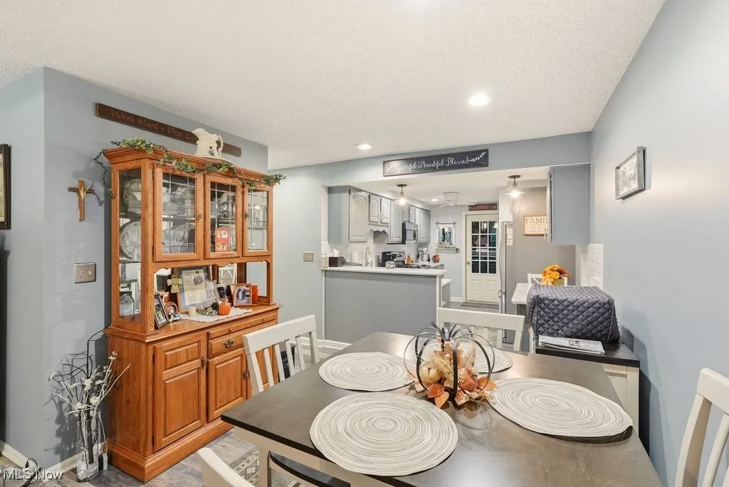 Dining space with a textured ceiling and recessed lighting