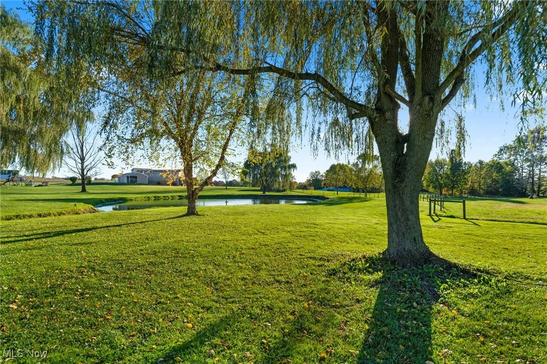 View of property's community with a lawn and a water view
