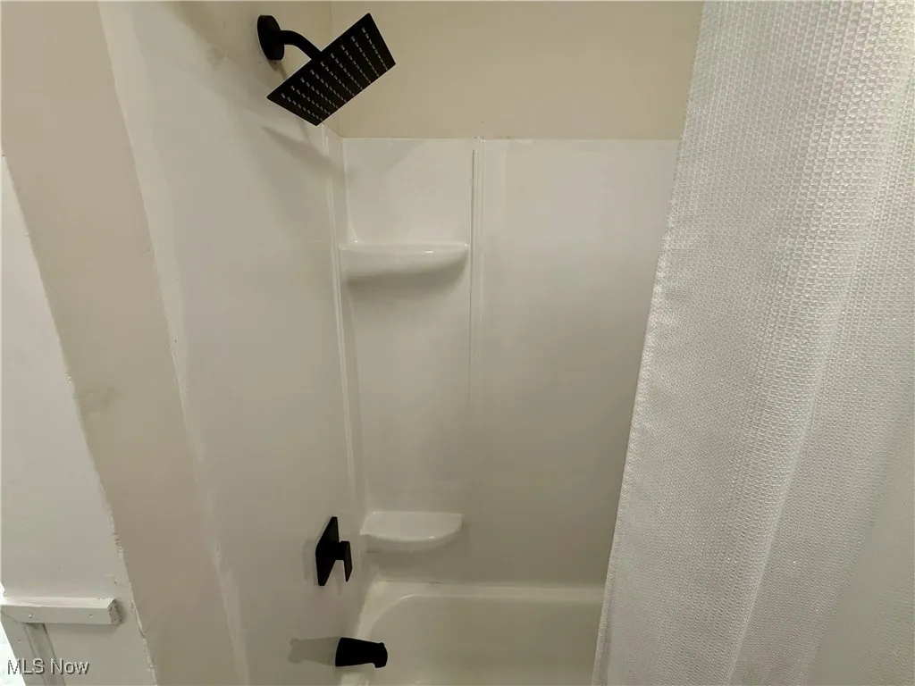 Bathroom with shower / tub combo with curtain