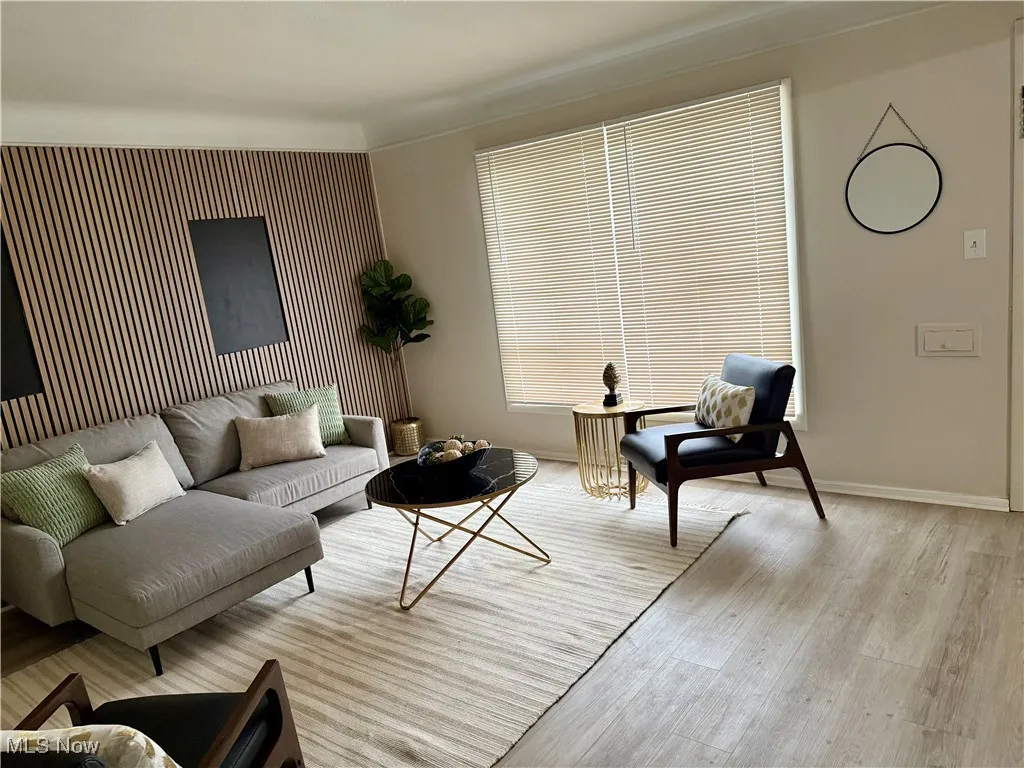 Living area featuring light wood-style floors and baseboards