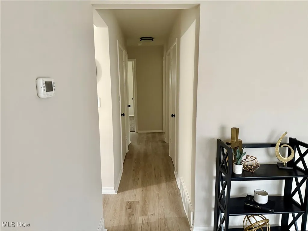 Hall featuring baseboards and light wood-style floors