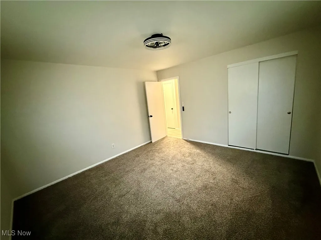 Unfurnished bedroom with carpet floors and a closet
