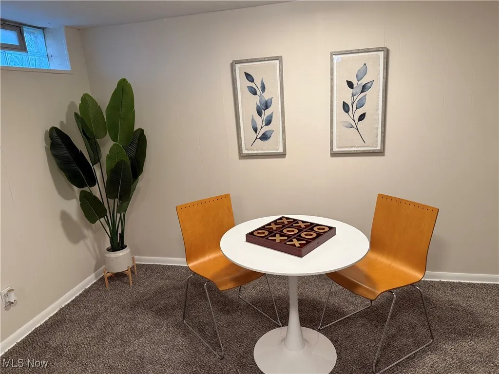 Carpeted dining room featuring baseboards