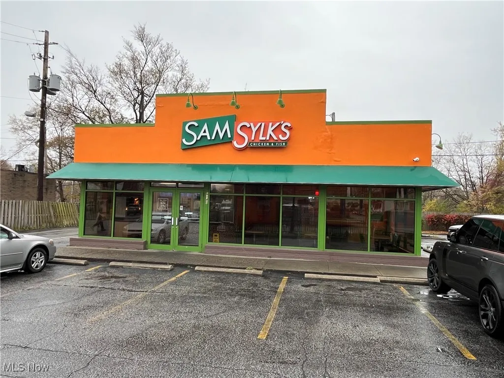 View of commercial property with uncovered parking