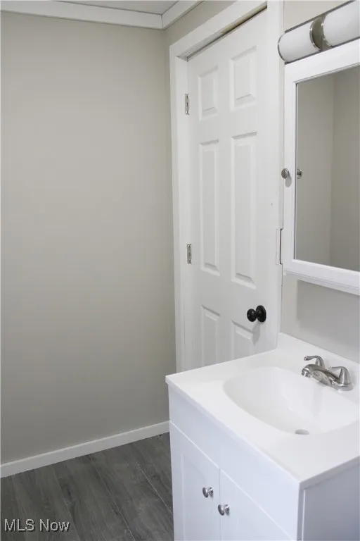 Bathroom with vanity and dark wood-style flooring