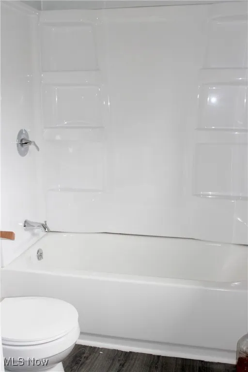 Bathroom with shower / tub combination and toilet