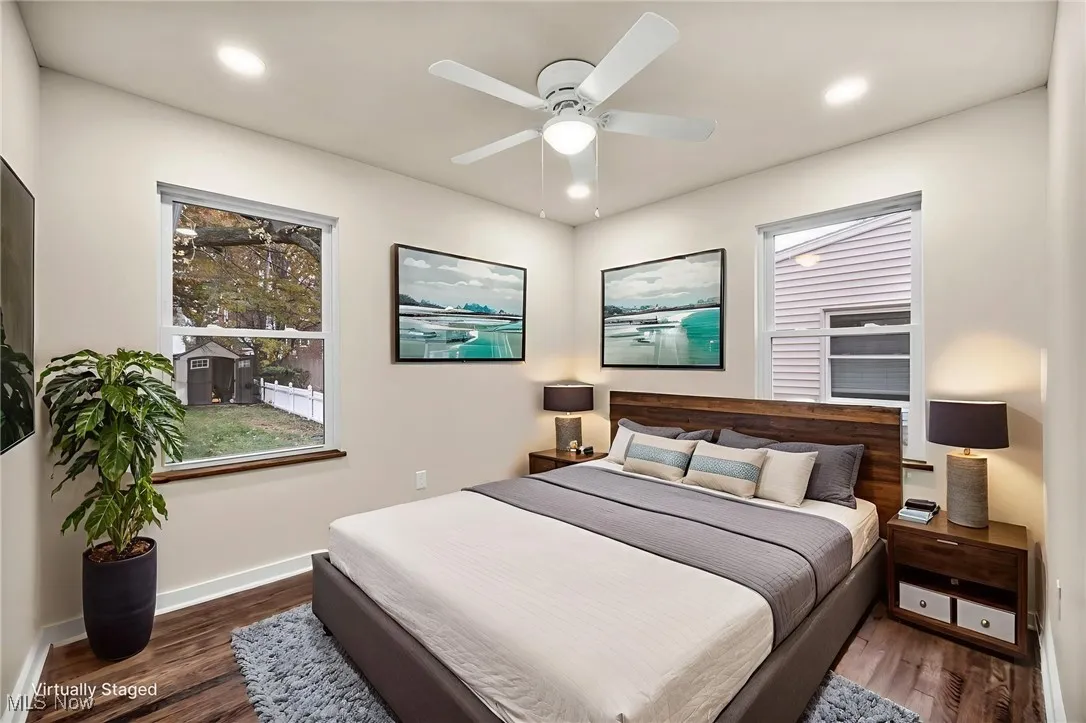 Bedroom featuring dark wood-style flooring, ceiling fan, recessed lighting, and multiple windows