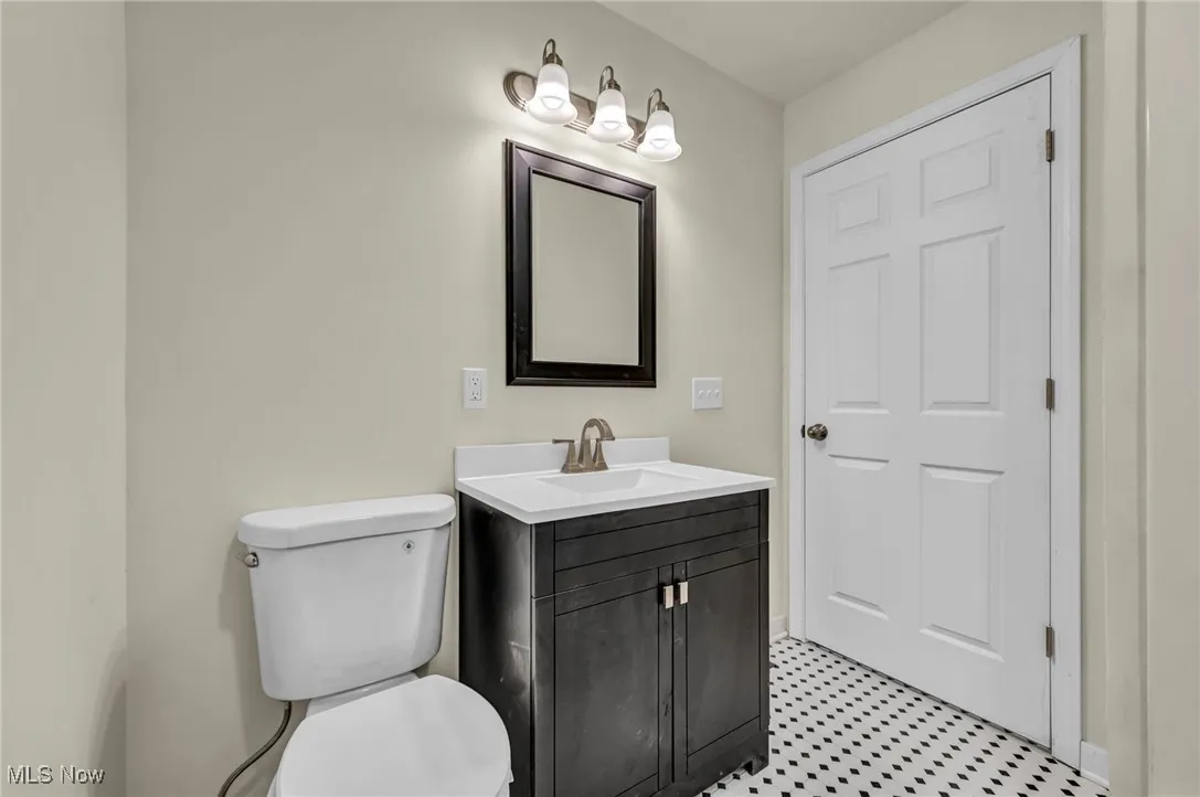 Half bath with vanity and toilet