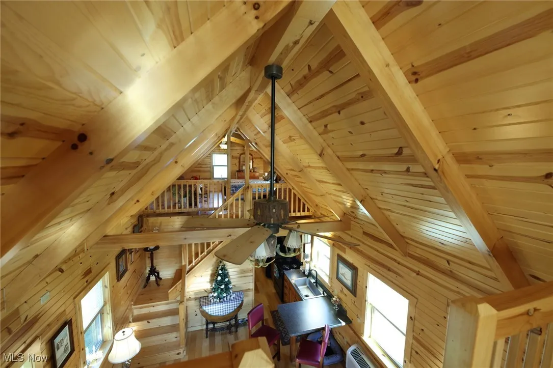 Detailed view of a wood ceiling with exposed beams and wood walls