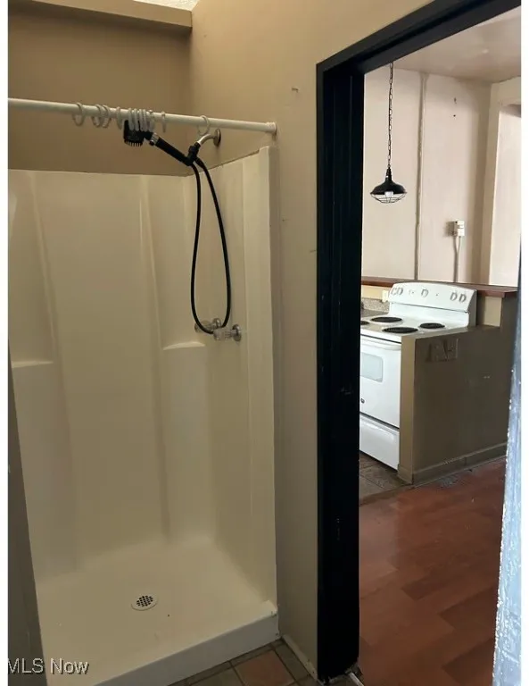 Full bathroom with a shower stall