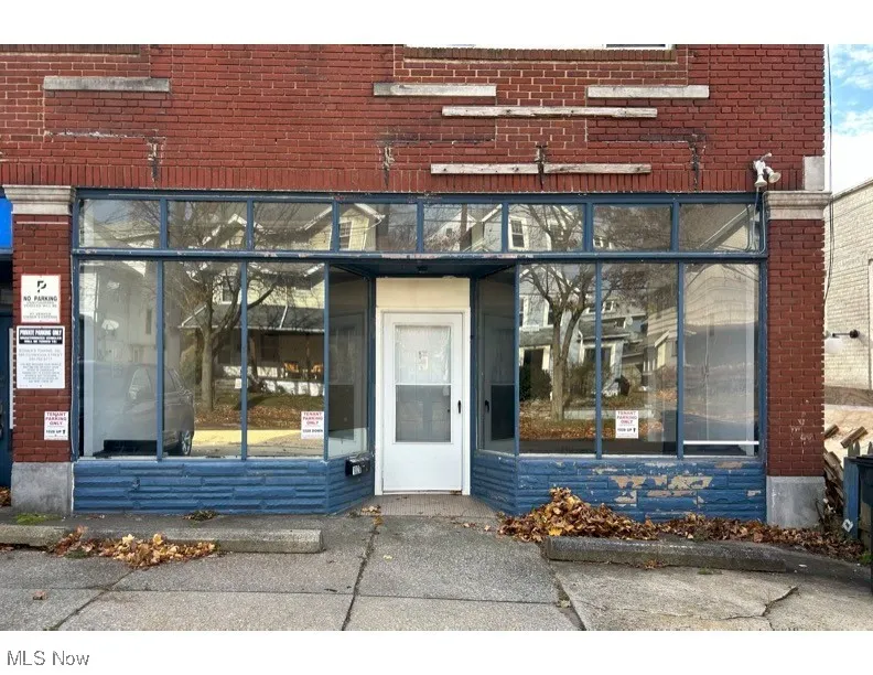 View of exterior entry with brick siding