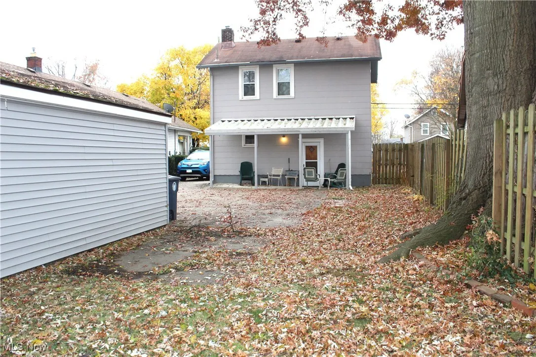 Back of property featuring a patio, a chimney, and a fenced backyard