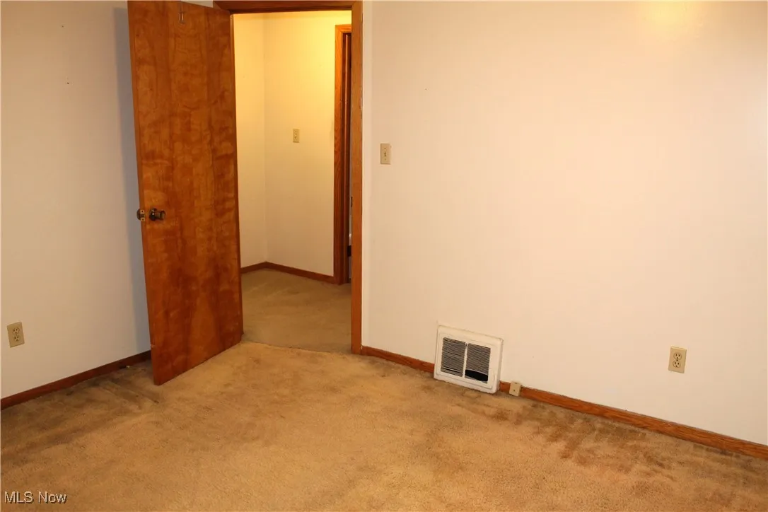 Bedroom with light carpet and baseboards