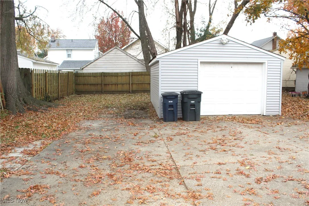 Detached garage featuring concrete driveway