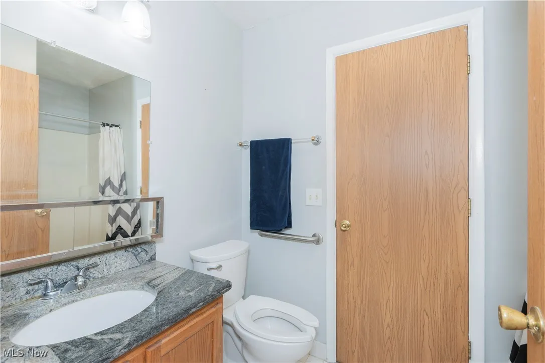 Full bath featuring vanity and a shower with shower curtain