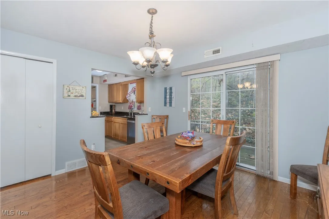 Dining area featuring light wood-style flooring and a chandelier