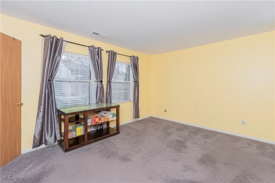 Unfurnished room featuring carpet floors and baseboards