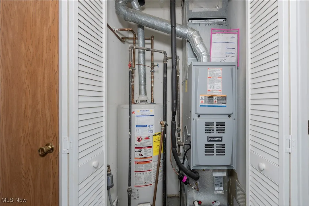 Utility room with gas water heater and heating unit