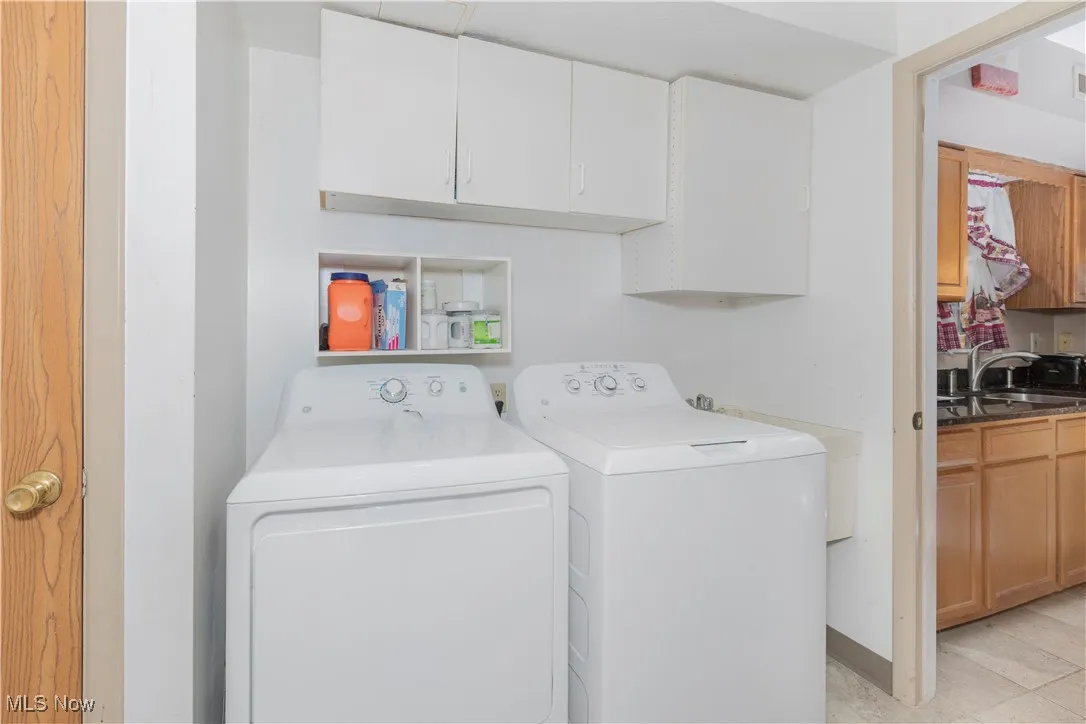 Laundry room featuring cabinet space and independent washer and dryer