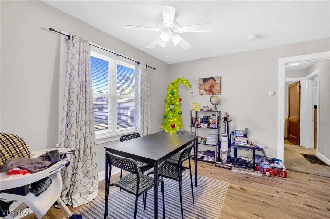 Dining area featuring LVT flooring and ceiling fan