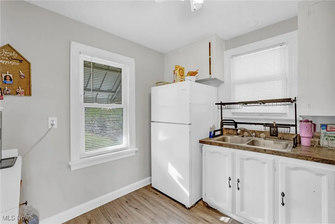Kitchen with white cabinets and LVT flooring