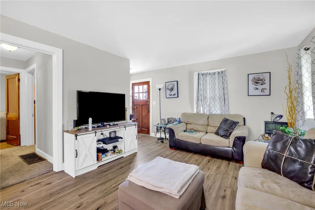 Living area featuring LVT floors and front entrance