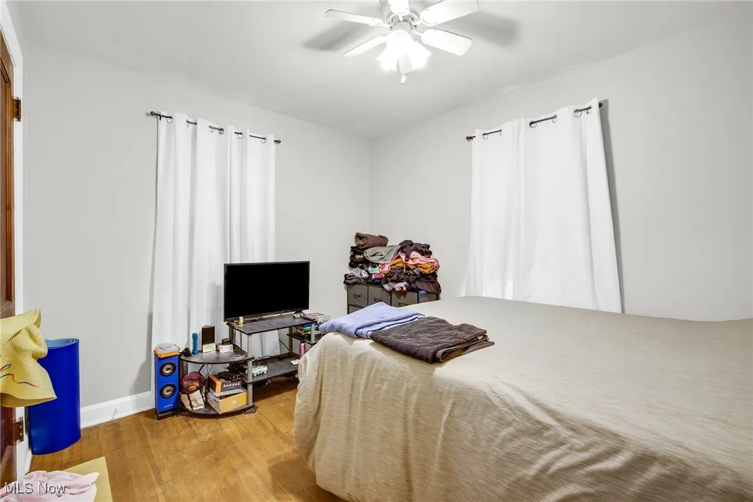 Bedroom with wood finished floors and a ceiling fan
