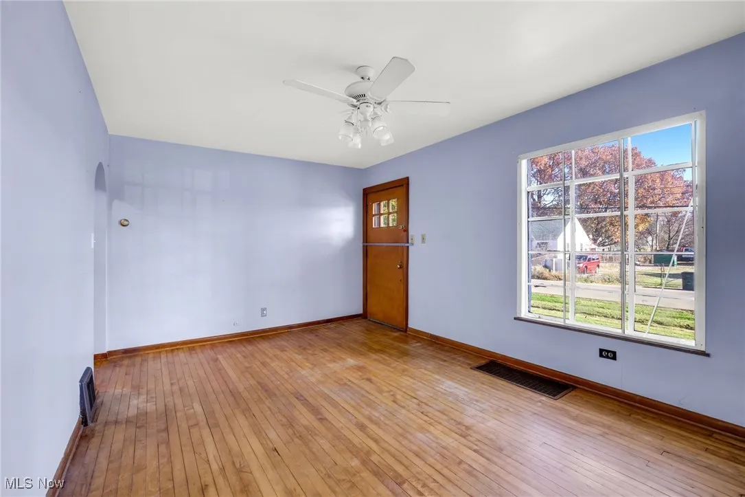 Living room featuring hardwood flooring and ceiling fan