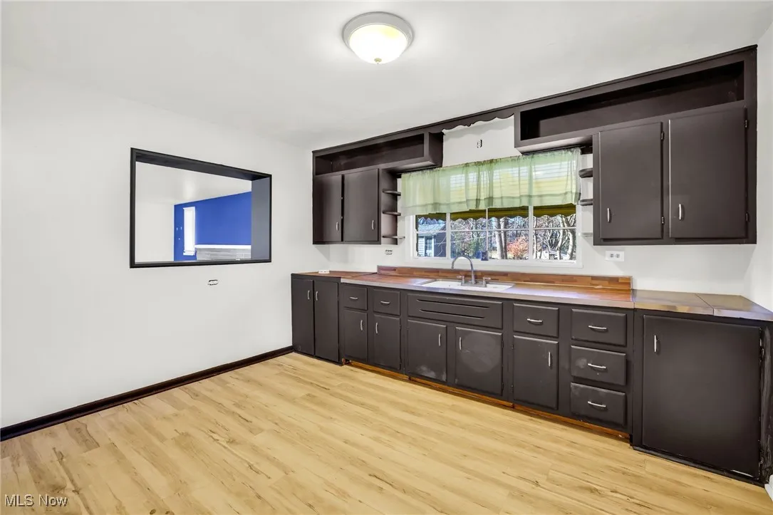 Kitchen with cabinets and laminate fllooring