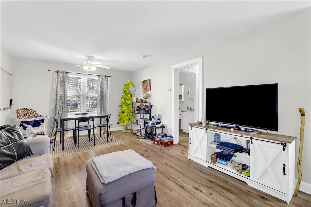 Living room/dining area featuring LVT flooring and ceiling fan