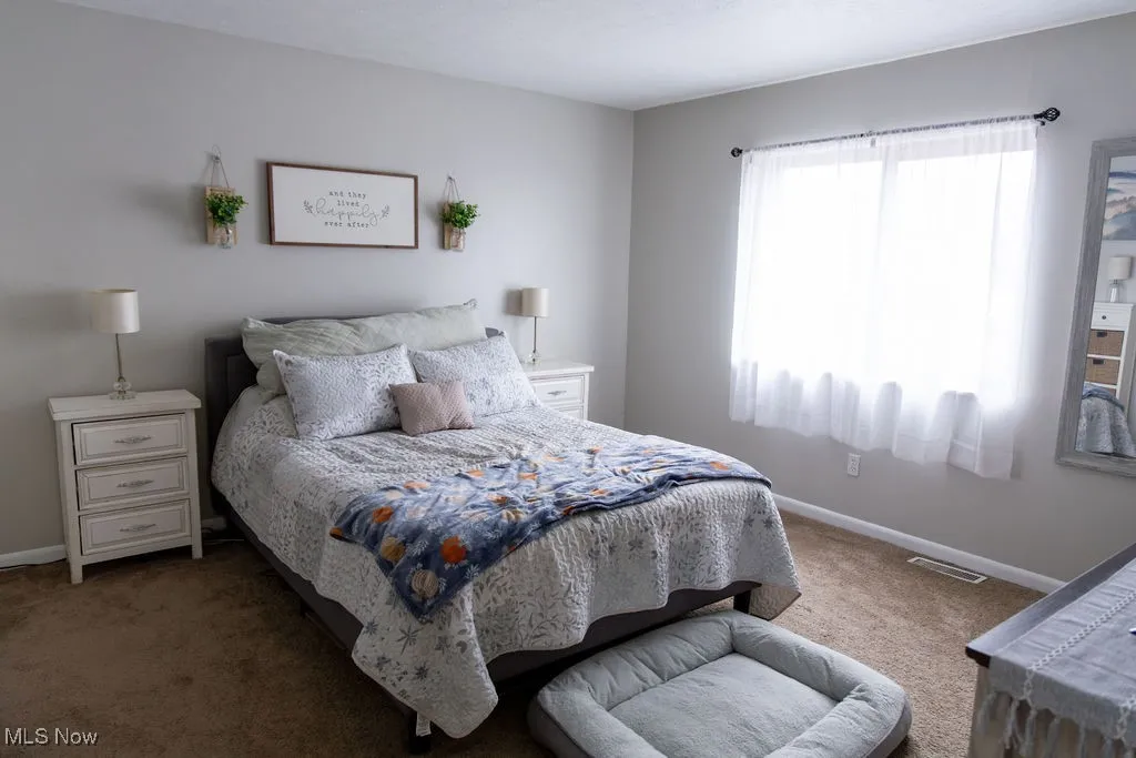 Carpeted bedroom with baseboards
