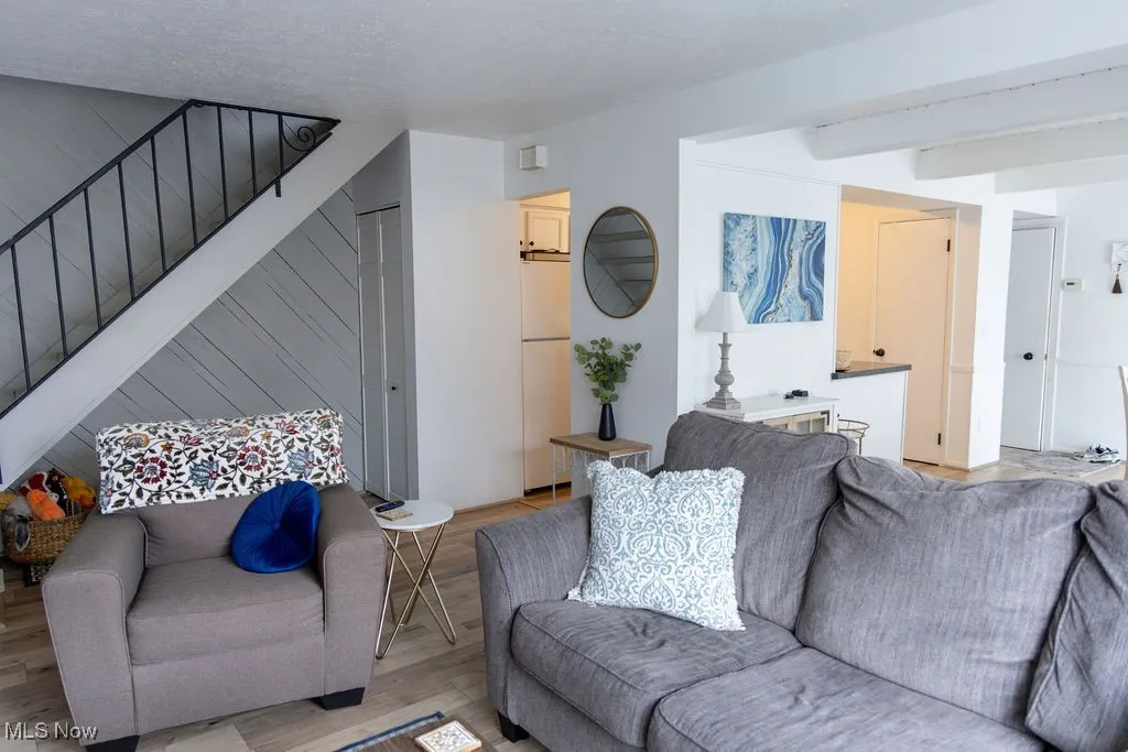 Living room with wood finished floors and stairs